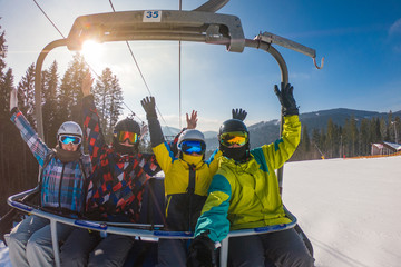 friends in ski lift taking selfie