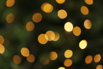 Abstract background with blurred yellow Christmas lights, bokeh effect