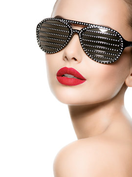 Fashion portrait of  woman wearing black sunglasses with diamonds and red lips