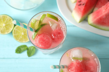 Delicious refreshing watermelon drink on blue wooden table, top view
