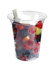 Fresh tasty fruit salad in plastic cup on white background