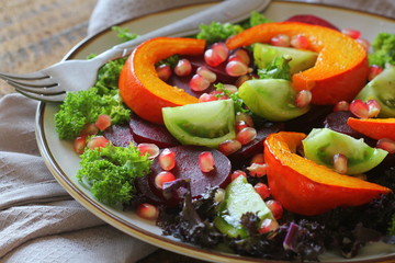 Healthy vegetarian salad, roasted pumpkin, tomato,pomegranate, kale, beet
