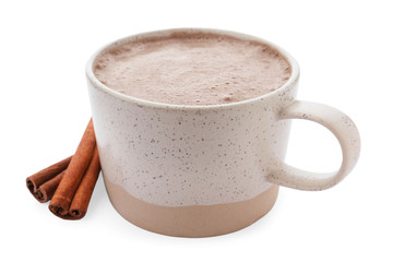 Delicious cocoa drink in cup and cinnamon sticks on white background