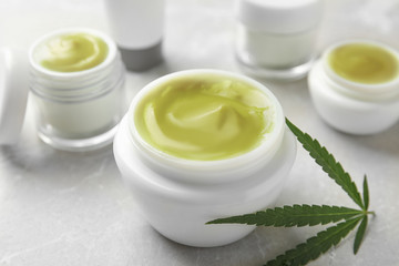 Obraz na płótnie Canvas Composition with jar of hemp cream on grey table, closeup. Organic cosmetics