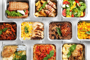 Lunchboxes on white wooden table, flat lay. Healthy food delivery