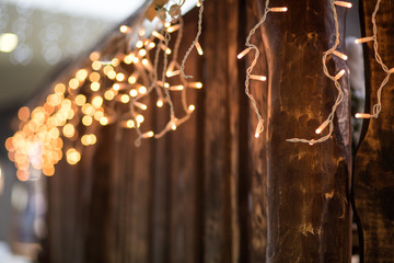 christmas decoration, lights garland over wooden planks