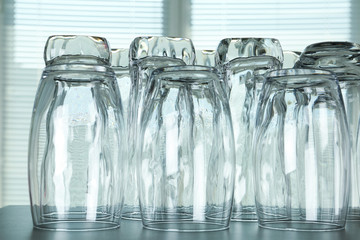 Empty glasses on grey table against blurred background, closeup