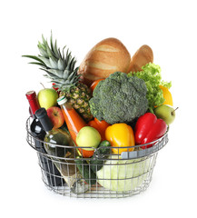 Shopping basket with grocery products on white background