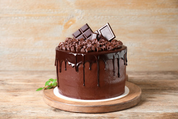 Freshly made delicious chocolate cake on wooden table