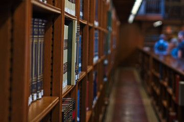 Inside of a public library with two hardcover books in focus