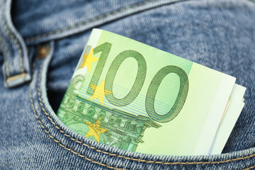 Euro banknotes in pocket of jeans, closeup
