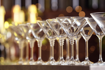 Empty martini glasses on table against blurred background