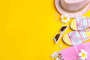 Flat lay composition with sunglasses and beach accessories on yellow background. Space for text