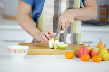 he is slicing varieties of fruits
