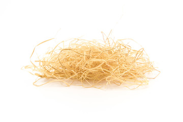 a slender curly sawdust hay closeup on a white background © bqmeng