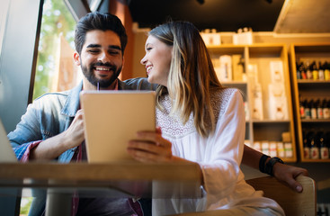 Portrait of a cheerful couple shopping online with laptop