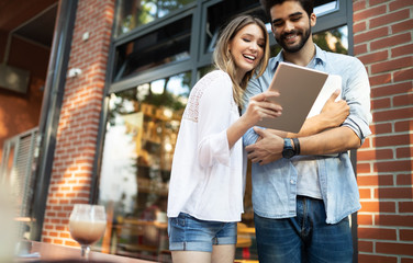 Young couple using a digital tablet together and smiling