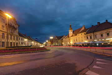 Naklejka premium Maribor, Slovenia-September 24, 2019: Morning view of medieval buildings against vibrant autumn sky. The Rotovz Town Hall Square in Maribor. Famous touristic place and travel destination in Slovenia