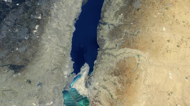 Salt ponds at Dead Sea aerial satellite view, Israel Jordan border. Contains public domain image by Nasa