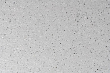 White abstract polystyrene foam texture background. Close-up detail view of plastic sheet, styrofoam, polystyrene abstract synthetic packaging material.