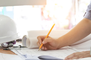 architect working and sketching architectural drawing plan on table