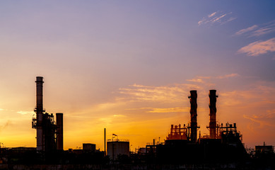 Fototapeta na wymiar Gas turbine electrical power plant. Energy for support factory in industrial estate. Natural gas tank. Small gas power plant. Power plant using natural gas for fuel. Green energy. Dramatic sunset sky.
