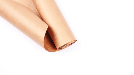 Twisted into roll brown wrapping paper on white background