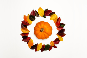 Colorful autumn ring leaves and pumpkin inside. Yellow green red.