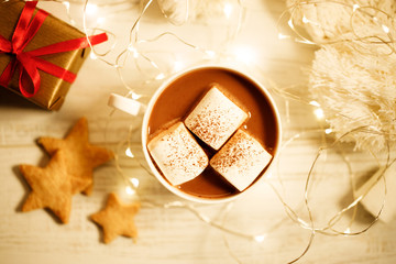 Hot chocolate with marshmallow on Christmas table background.
