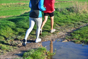 couple running on wet country roads