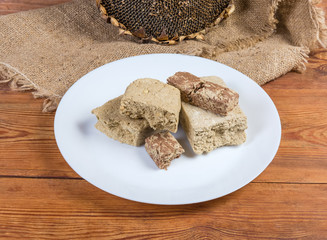 Sunflower halva with different addition against dry ripe sunflower head