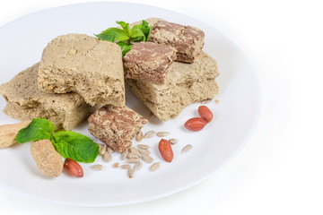 Sunflower halva with different addition, sunflower seeds, peanuts on dish
