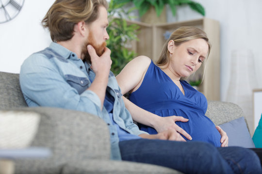 pregnant woman at home experiencing pain