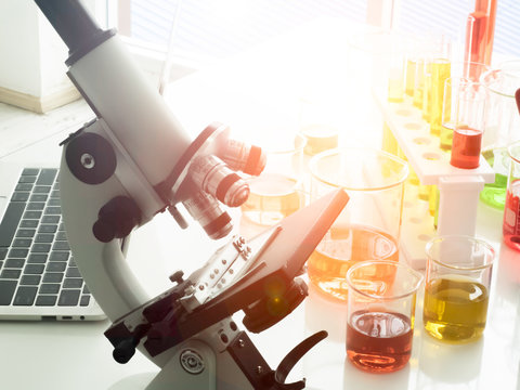 In the orange lab there are many scientific instruments such as telescopes, microscopes, test tubes, computers, notebooks for research.