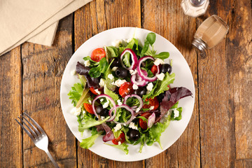 mixed vegetable salad with onion, tomato, olive and cheese