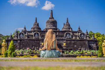 Young woman tourist in budhist temple Brahma Vihara Arama Banjar Bali, Indonesia