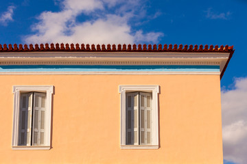 Old window shutters on orange home