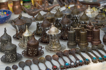 Bronze spoons, pepper mills and teapots on the counter of the Oriental Bazaar