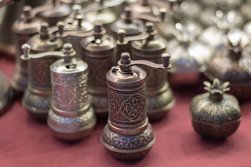 Fototapeta na wymiar Silver pepper mills on the counter of the Oriental Bazaar. Oriental style
