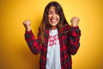 Beautiful woman wearing funny t-shirt with irony comments over isolated yellow background screaming...