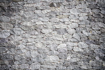 background texture of gray stone wall with vignette
