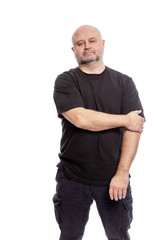 Fototapeta premium A serious bald middle-aged man is standing. Isolated over white background. Vertical.