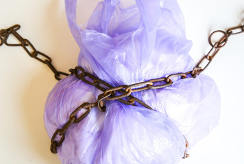 Smuggling. Old rusty chains around the plastic bag. Environmental pollution. Eco-friendly concept.