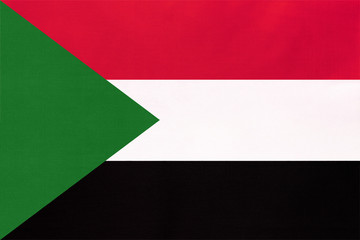 Republic of Sudan national fabric flag, textile background. Symbol of world African country.