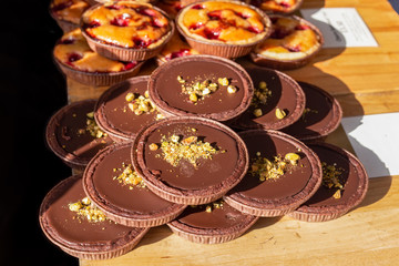 Chocolate and pistachio tarts on a market stall in the UK