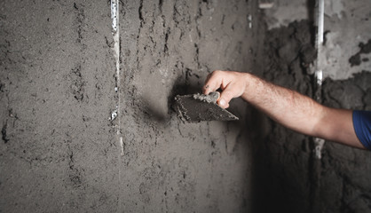 Worker plastering wall. Construction work