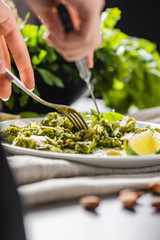Italian lunch. Fresh, delicious pasta with pesto, parmesan and lime. Close-up.