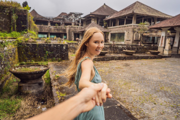 Woman tourist in abandoned and mysterious hotel in Bedugul. Indonesia, Bali Island. Bali Travel Concept. Follow me concept Follow me concept
