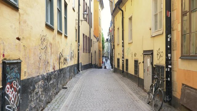 Narrow alley in Old Town, Stockholm, Sweden. Grafitti on the exterior walls.