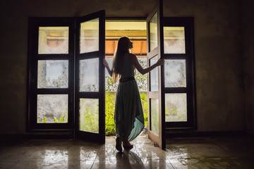 Woman tourist in abandoned and mysterious hotel in Bedugul. Indonesia, Bali Island. Bali Travel Concept